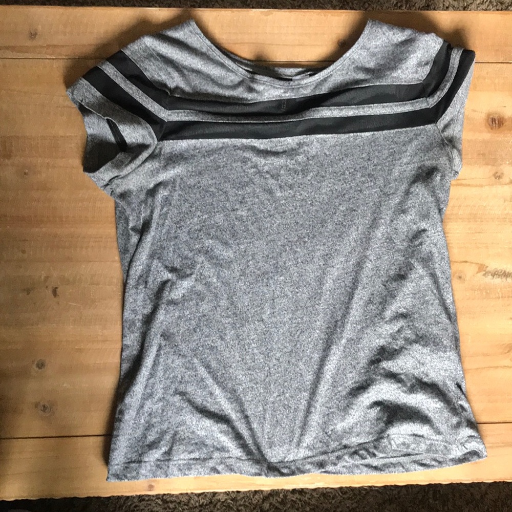 Grey T shirt with mesh striped on top.